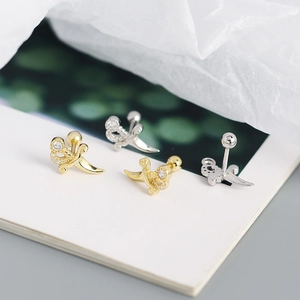 Detailed view of gold and silver dagger stud earrings with crystal-encrusted handles