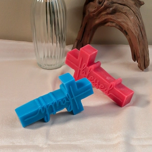 Detail view of cross candles featuring faith and blessed text on satin fabric
