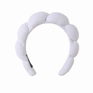 Close-up of white braided towel fabric headband with thick bubble texture for women