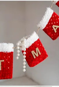 Close-up of red sequined Christmas stockings with gold letters on a white plush trim