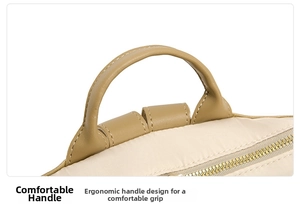 Macro shot of the soft beige leather handle with reinforced stitching on the backpack