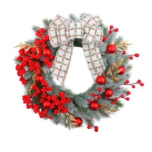 Christmas wreath with red berries, frosted pine needles, and a plaid bow decoration