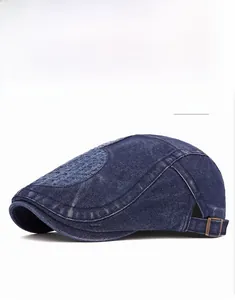 Detail of dark blue denim ivy cap featuring vintage washed texture and metal buckle