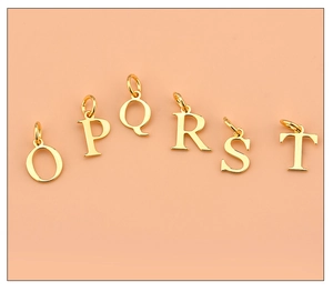 Detailed view of gold plated 925 silver alphabet charms O to T on pink background