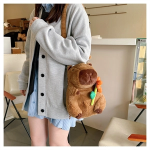 Brown capybara plush crossbody bag with orange flower detail worn by a model in a cafe