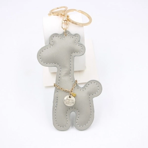 Gray faux leather giraffe keychain with golden metal ring on a clean white background