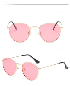 Detailed view of retro round polarized sunglasses with gold frame and pink lenses