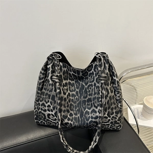 Large leopard print tote bag in black and grey on a sofa, stylish commute shoulder bag