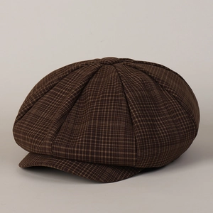 Detailed view of dark brown plaid octagonal newsboy hat with textured wool stitching