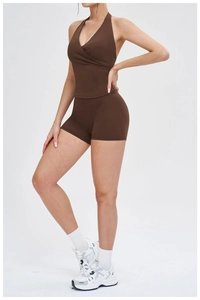 Detail view of dark coffee halter neck yoga top and high-waist sports shorts set