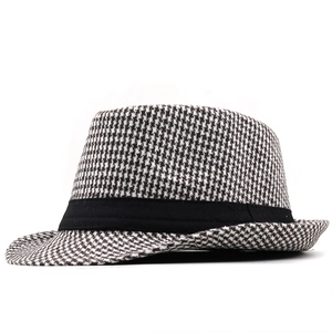 Classic houndstooth fedora hat with black ribbon band on a white background