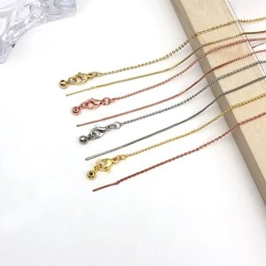 Detail view of 14k gold adjustable chain necklaces in gold, silver, and rose gold finishes