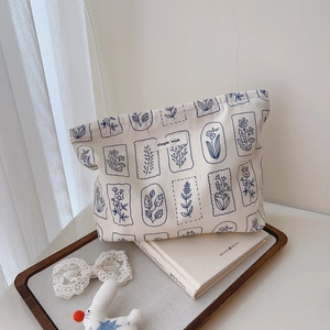 Detail of floral canvas pouch with simple wish label on a wooden tray with lace
