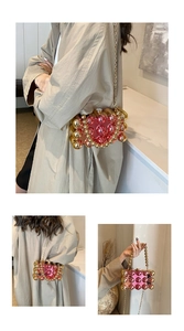 Detail of beaded handbag with gold and pink acrylic beads and a gold chain strap