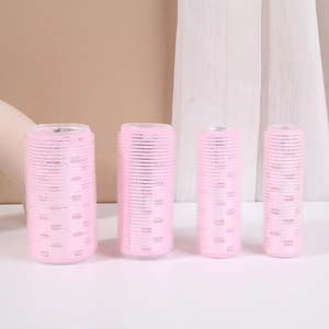 Pink self-grip hair rollers set in different sizes for styling air bangs and volume