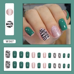 Detail of W367 press-on nails featuring green, pink glitter and zebra print designs