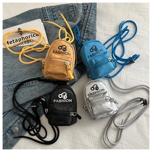 Mini backpack style coin purses in yellow, blue, black, and silver with neck straps