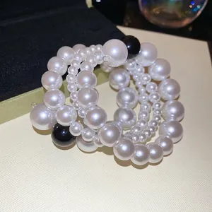 Elegant multi-layer twisted pearl bracelet with contrasting black and white resin beads