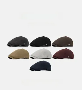 Detail of wool newsboy caps in seven colors with metallic logo accents