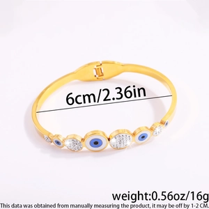 Detail of gold evil eye bangle with rhinestones and hinge clasp, 6cm diameter size