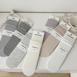 Women's cotton crew socks set in various pastel colors with ribbed texture and slouchy cuffs