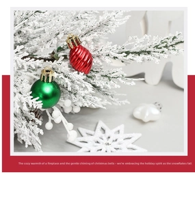 Detailed view of red spiral and green smooth Christmas balls hanging on snow-covered pine