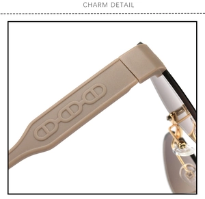 Detail of khaki rimless sunglasses temple with CD logo pattern and metal hinge