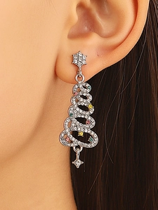 Detailed view of silver Christmas tree earrings with colorful crystal rhinestones on ear