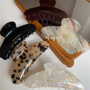 Large arched hair claw clips in tortoise shell and pearlescent finishes for women