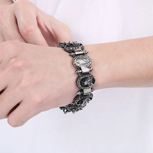 Detailed close-up of retro punk wolf head carved links on a silver steel men's bracelet