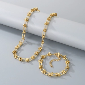 Detail of gold knot link chain necklace and bracelet set with lobster clasp and extender