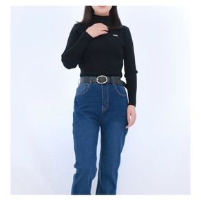 Detail shot of a black PU leather belt with a metal pin buckle on blue jeans
