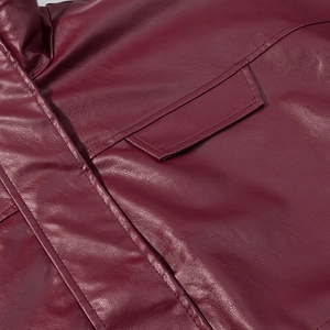 Detailed close-up of burgundy leather texture and precise double stitching on cargo jacket