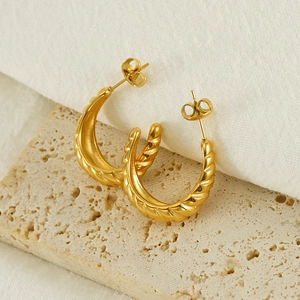 18K gold plated C-hoop earrings with twisted spiral texture on natural stone background