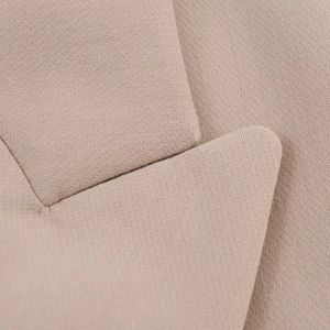 Detailed macro shot of the notched lapel and premium textured fabric on the blazer