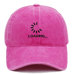 Close-up of pink washed cotton baseball cap with LOADING embroidery and vintage worn texture