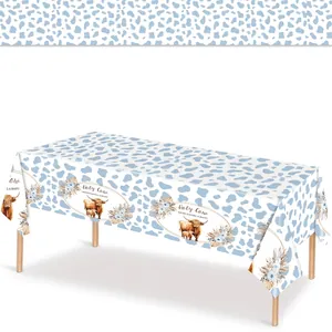 Holy Cow baby shower table cover with blue cow print pattern for birthday party