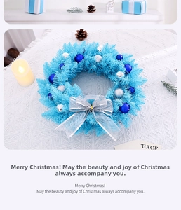 Detail of blue Christmas wreath with silver bow, ornaments, and pine needles decor