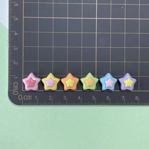 Detailed view of 1cm colorful resin star charms for DIY crafts and nail art jewelry