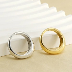 Close-up of minimalist thick band rings in gold and silver finish with metallic shine