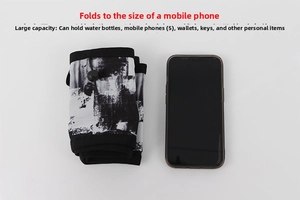 Foldable camo sports waist pack shown next to a smartphone to display compact size