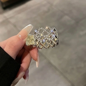 Macro shot of a rectangular metal hair claw clip with sparkling clear rhinestones