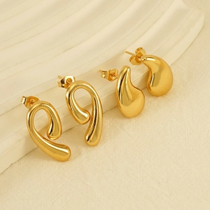 Chic 18K gold plated teardrop and spiral hollow earrings set on artistic display