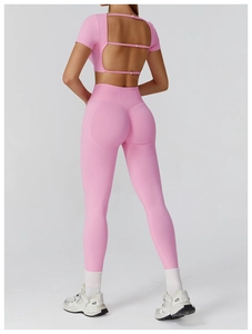 Macro detail of the bright pink seamless yoga top showing the hollow back strap design