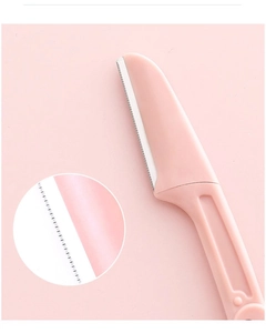 Close-up of pink eyebrow razor with protective micro-guard blades for skin safety