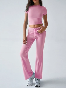 Detail view of pink two-piece set featuring short sleeve t-shirt and wide leg trousers