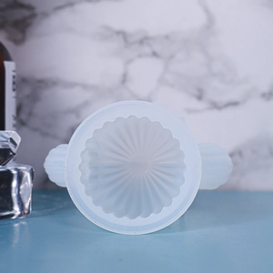 Top view of translucent cactus candle silicone mold with radial texture and dual handles