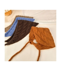 Flat lay of vintage knitted headbands in brown, blue, and khaki with cable textures