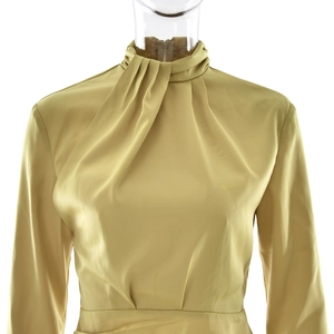 Detailed view of elegant gold satin high neck dress with sophisticated chest pleats
