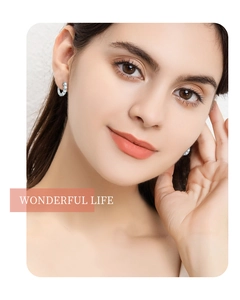 Close-up of S925 silver hoop earrings with moissanite on a female model's ear